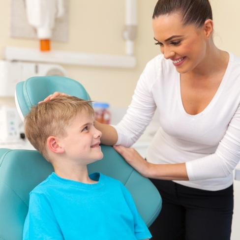 Pediatric dental team member smiling at dental patient