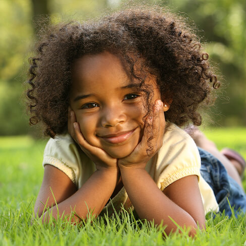 Young girl smiling outdoors