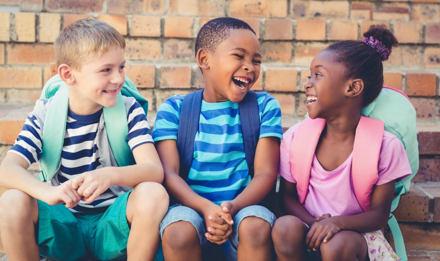 Children laughing together after emergency kids dentistry