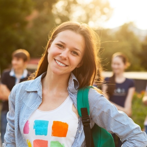 Young woman smiling after dentistry for teens