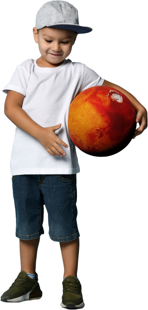 Smiling young boy holding an oversized toy ball designed to look like Mars