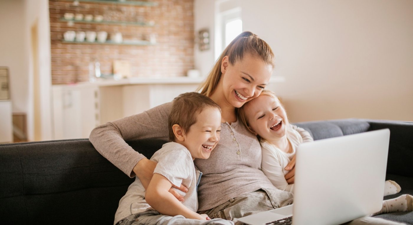 Mother and children smiling after saving on treatment with dental insurance