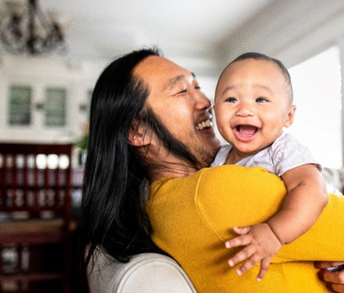 a father holding his baby 