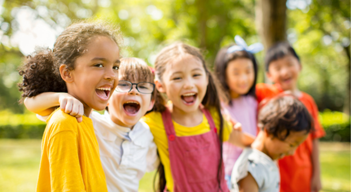 Group of happy children playing outdoors