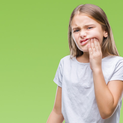 Frowning young girl dealing with a toothache