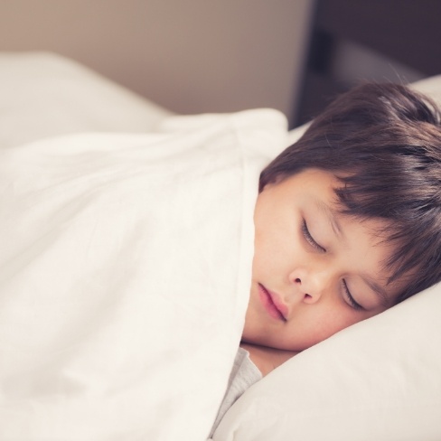 Child resting after dental treatment under general anesthesia