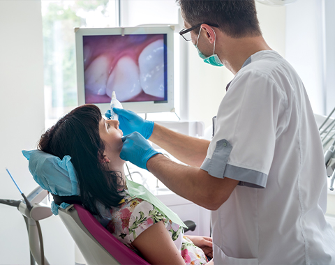 Dentist using intraoral camera to capture smile images