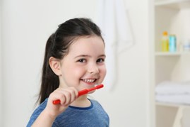 child brushing teeth during cold and flu season