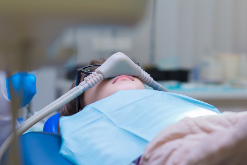 Child with a nasal mask on in the dental chair.