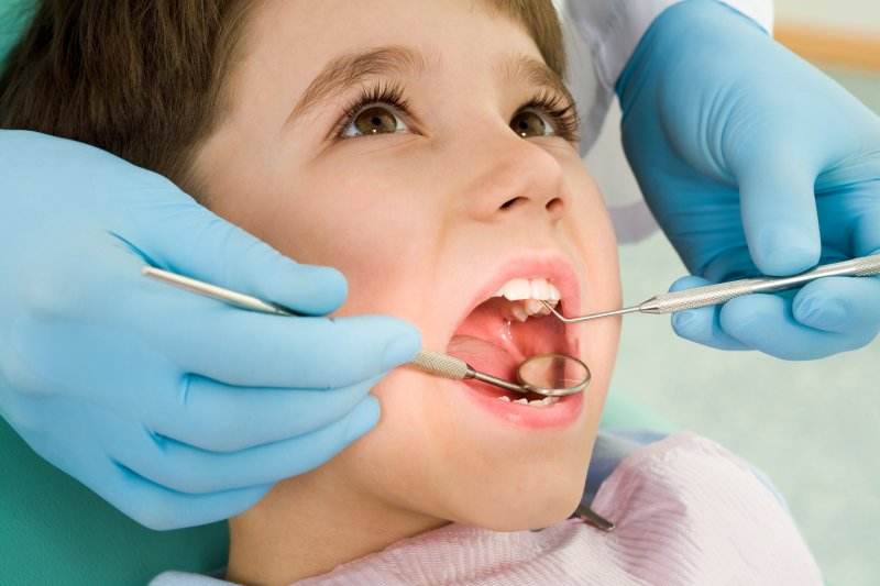 Child being examined by dentist.